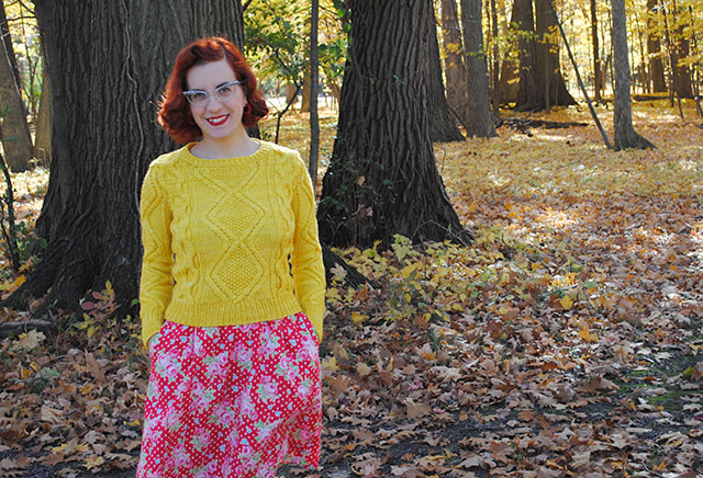 A chunky cabled pullover and fallen leaves